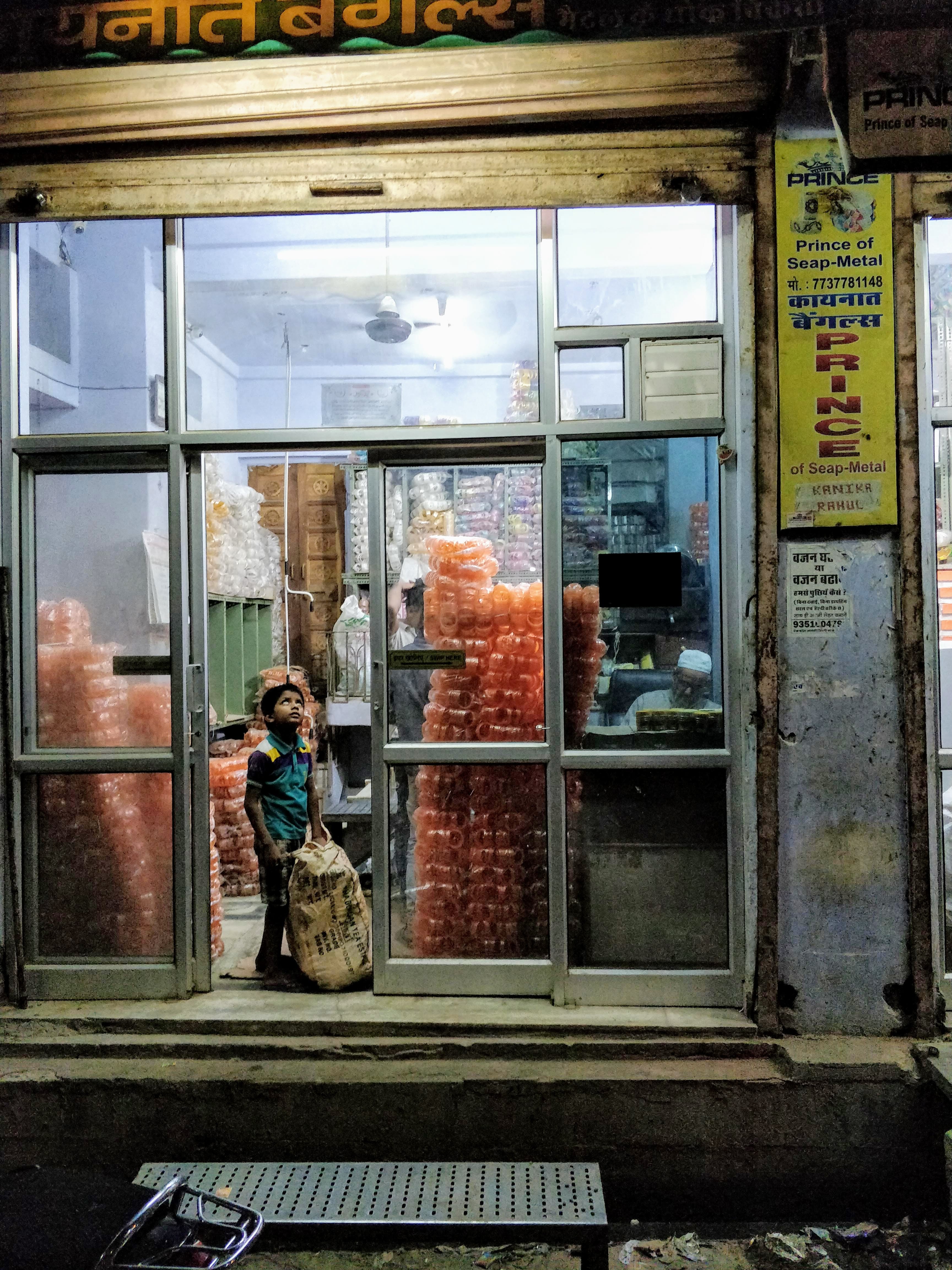 Child helping his father — India