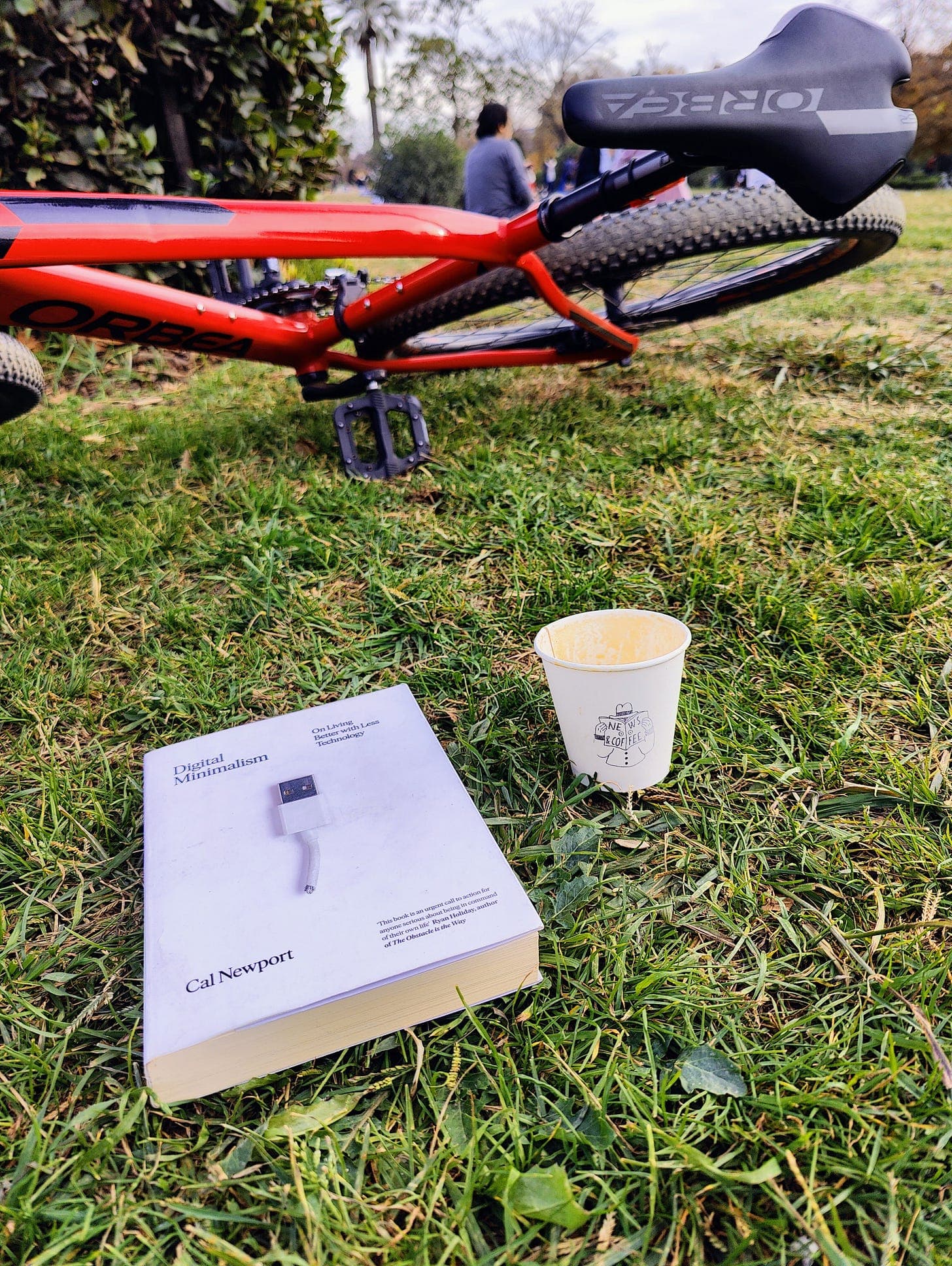 Reviewing the book in the park with a nice flat white